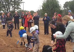 Small kids use shovels to celebrate groundbreaking of Montessori for All's new building